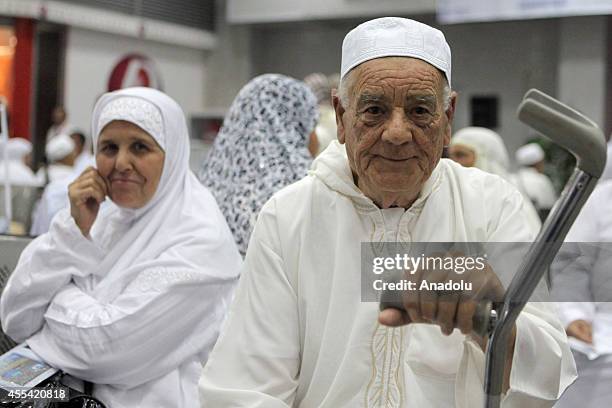 Muslim prospective pilgrims pose as they wait to flight for the Muslim Holy Land at International Carthage Airport in Tunis, Tunisia on September 13,...
