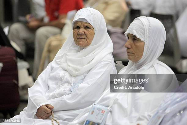 Two Muslim prospective pilgrim wait before his flight to the Muslim Holy Land at International Carthage Airport in Tunis, Tunisia on September 13,...