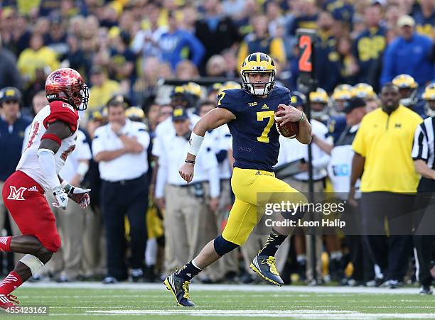 Quarterback Shane Morris of the University of Michigan runs for a first down during the fourth quarter of the game against the Miami University...
