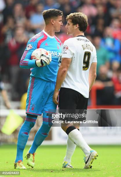 Karl Darlow of Nottingham Forest squares up to Chris Martin of Derby County during the Sky Bet Championship match between Nottingham Forest and Derby...