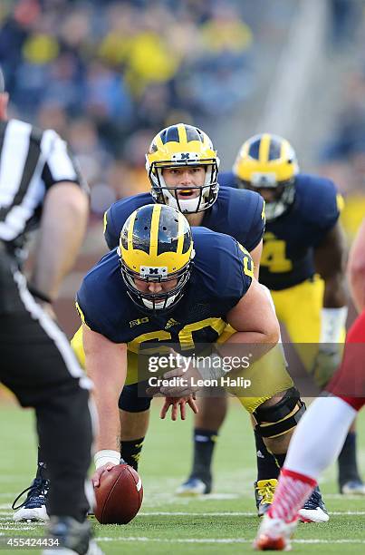 Quarterback Shane Morris and center Jack Miller of the University of Michigan line up during the fourth quarter of the game against the Miami...