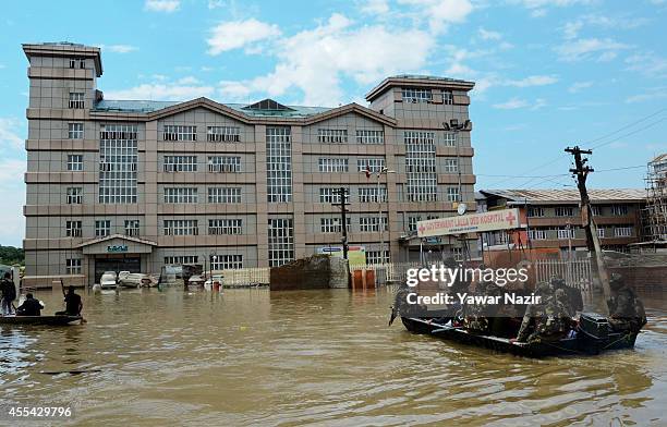 Indian army soldiers from the rescue wing row their boat in front the submerged Lal Ded hospital, the only government maternity hospital in the...