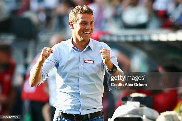 Head coach Markus Weinzierl of Augsburg celebrates after the Bundesliga match between Eintracht Frankfurt and FC Augsburg at Commerzbank-Arena on...
