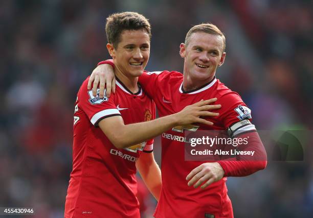 Wayne Rooney of Manchester United celebrates scoring the third goal with team-mate Ander Herrera , during the Barclays Premier League match between...