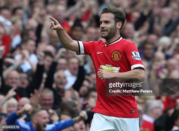 Juan Mata of Manchester United celebrates scoring their fourth goal during the Barclays Premier League match between Manchester United and Queens...