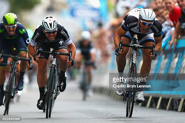 Mark Cavendish of Great Britain and Omega Pharma-QuickStep sprints against Marcel Kittel of Germany and the Giant-Shimano Team during stage 8b of the...
