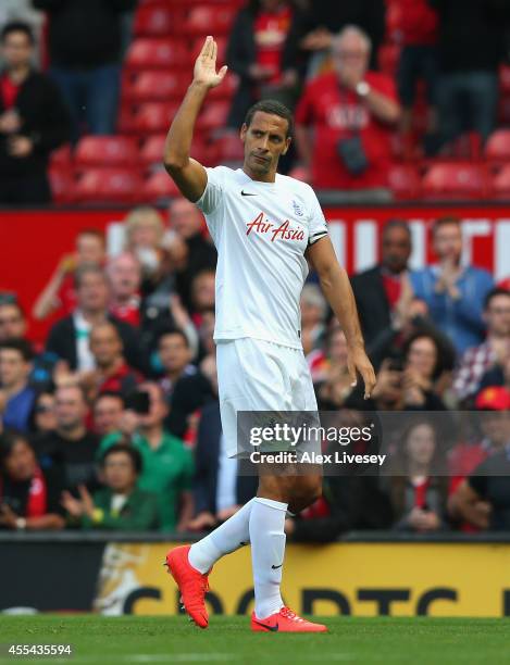 Rio Ferdinand of QPR salutes the crowd at the end of the Barclays Premier League match between Manchester United and Queens Park Rangers at Old...