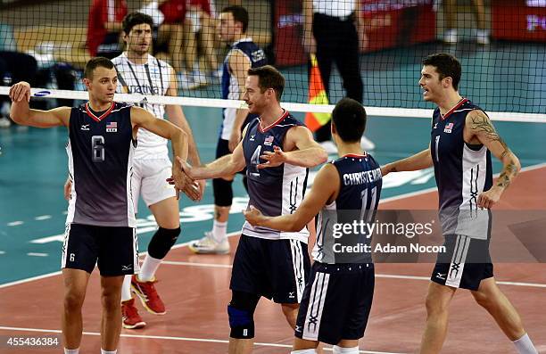 Team USA celebrate after winning a point during the FIVB World Championships match between Argentina and USA on September 14, 2014 in Bydgoszcz,...