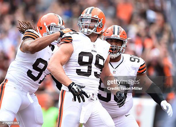 Paul Kruger celebrates his sack with Billy Winn of the Cleveland Browns and Jabaal Sheard of the Cleveland Browns during the first quarter against...