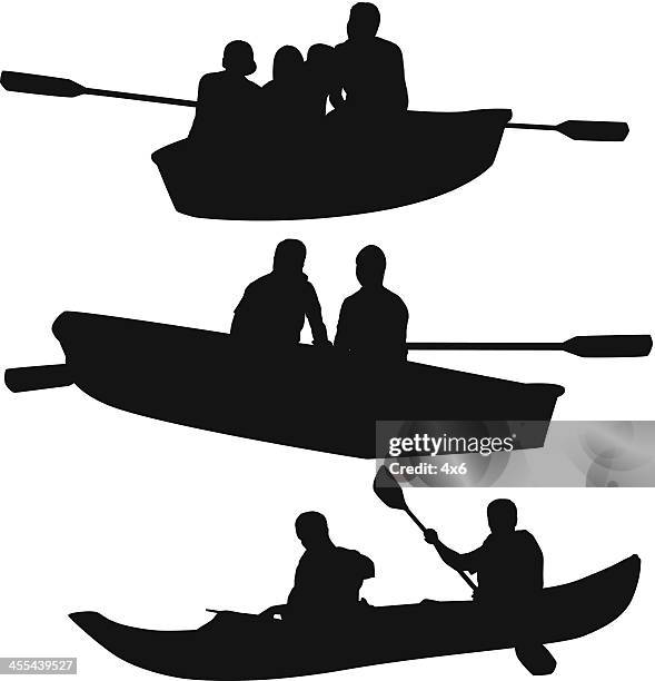 silhouette of people canoeing - people on canoe clip art stock illustrations