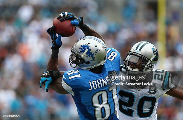 Calvin Johnson of the Detroit Lions catches the ball against Antoine Cason of the Carolina Panthers during the game at Bank of America Stadium on...