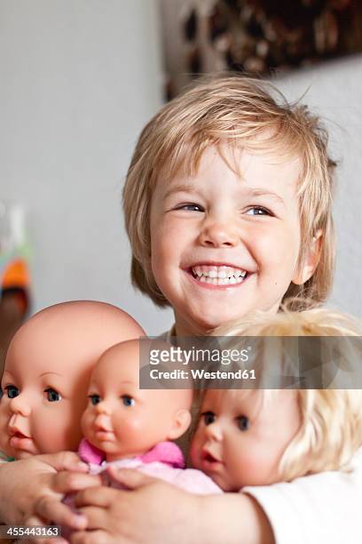 germany, girl with her dolls, smiling - blonde fille photos et images de collection