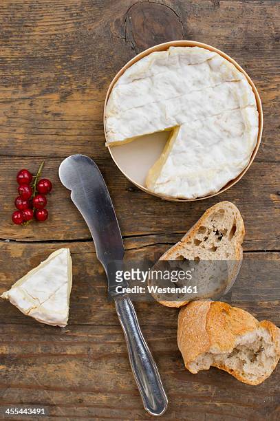camember cheese with red currant and baguette on wooden table - camambert bildbanksfoton och bilder