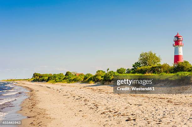 germany, schleswig holstein, view of lighthouse at beach - schleswig holstein stock-fotos und bilder