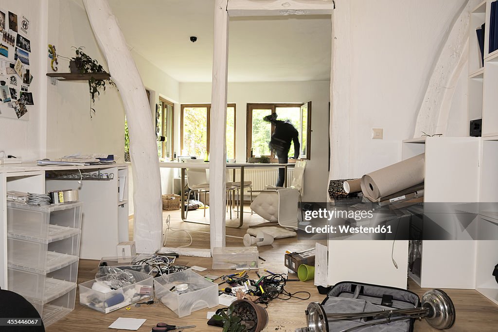 Germany, North Rhine Westphalia, Mature man running through window