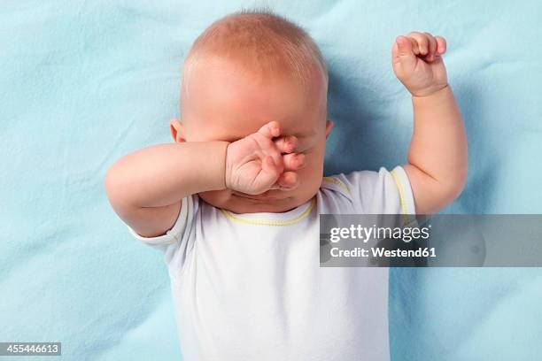 germany, bavaria, baby boy rubbing eyes - rubbing eyes stock pictures, royalty-free photos & images
