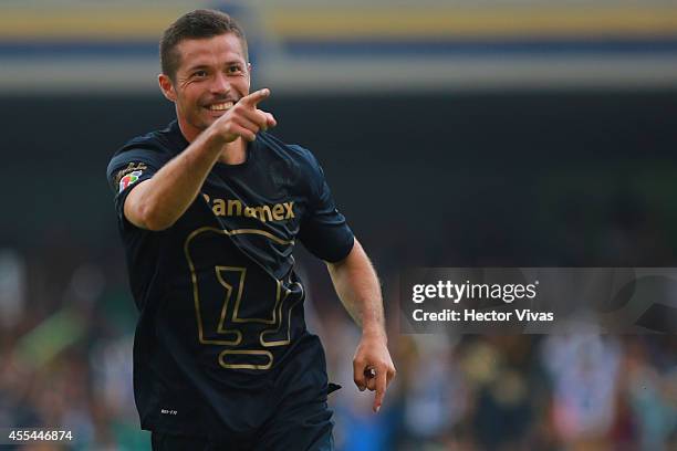 Dante Lopez of Pumas celebrates after scoring the opening goal against Tigres during a match between Pumas UNAM and Tigres UANL as part of 8th round...