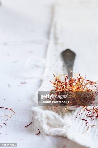 saffron on spoon, close up - saffron stock-fotos und bilder