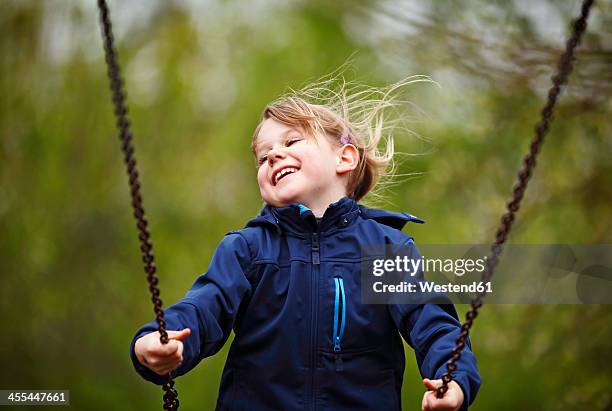 germany, baden wuerttemberg, girl swinging on swing - air child play stock-fotos und bilder