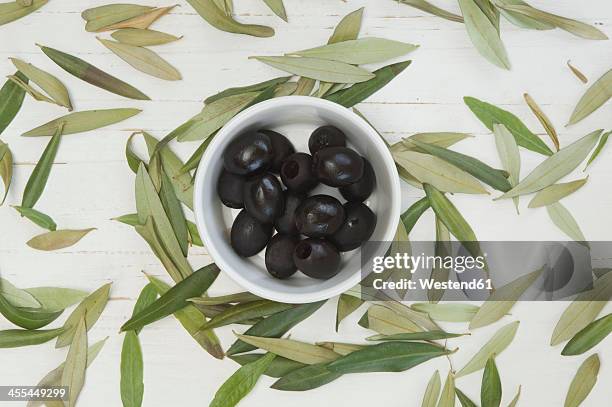 black olives with leaves, close up - black olive stock pictures, royalty-free photos & images