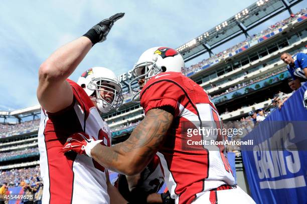 Wide receiver Ted Ginn of the Arizona Cardinals celebrates a touchdown after running back a punt against the New York Giants during a game at MetLife...