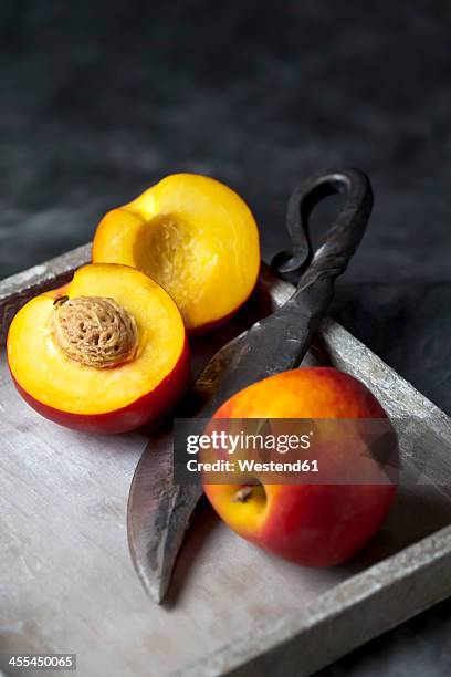 peaches with knife on tray, close up - nectarine photos et images de collection