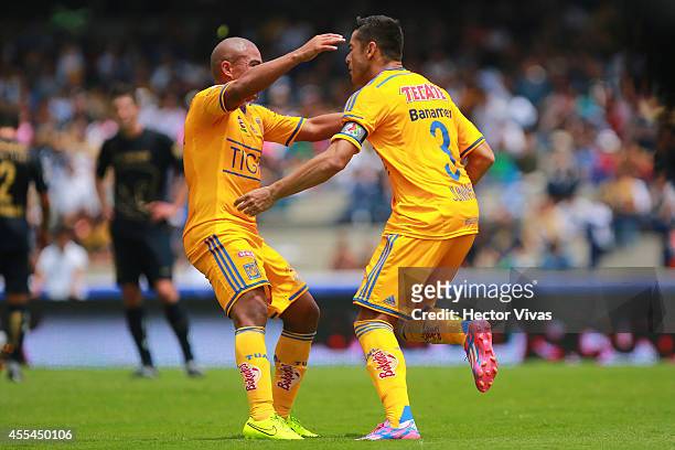 Anselmo Vendrechovski of Tigres celebrate with Egidio Arevalo after scoring the second goal of his team during a match between Pumas UNAM and Tigres...