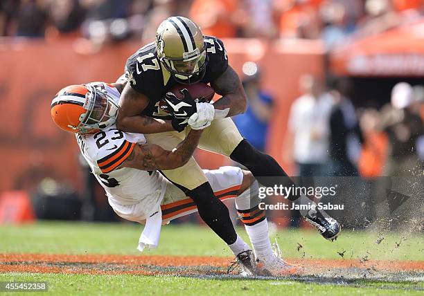 Robert Meachem of the New Orleans Saints gets tackled by Joe Haden of the Cleveland Browns during the fourth quarter at FirstEnergy Stadium on...