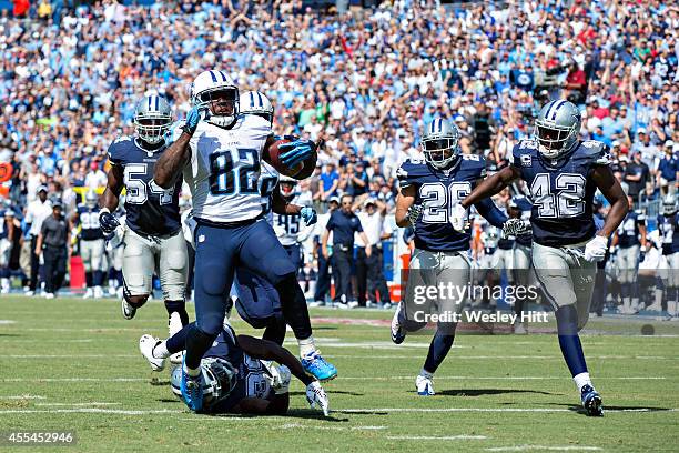 Delanie Walker of the Tennessee Titans runs for a touchdown after catching a pass against the Dallas Cowboys at LP Field on September 14, 2014 in...