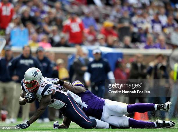Jasper Brinkley of the Minnesota Vikings tackles Stevan Ridley of the New England Patriots during the fourth quarter of the game on September 14,...