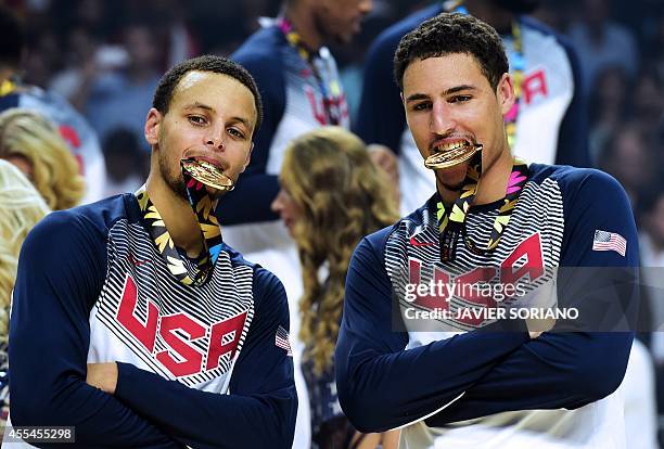 Guard Stephen Curry and US forward Rudy Gay bite their gold medals after winning the 2014 FIBA World basketball championships final match USA vs...