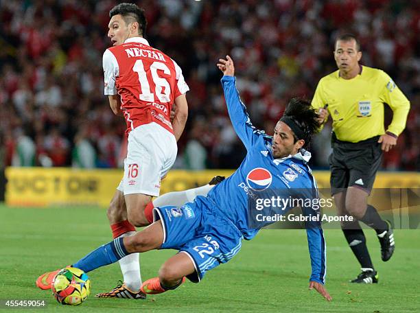 Fabian Vargas of Millonarios struggles for the ball with Daniel Torres of Independiente Santa Fe during a match between Millonarios and Independiente...