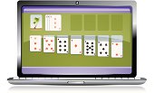 Laptop screen showing a running game of solitaire