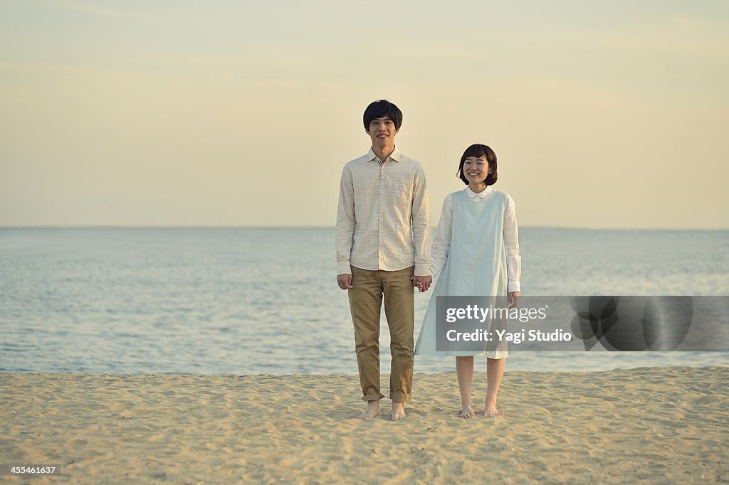 Couple standing together on beach