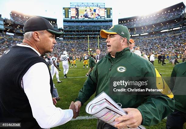 Head coaches Rex Ryan of the New York Jets and Mike McCarthy of the Green Bay Packers shake hands following the NFL game at Lambeau Field on...