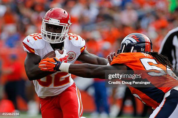 Running back Cyrus Gray of the Kansas City Chiefs works to break a tackle attempt by outside linebacker Danny Trevathan of the Denver Broncos during...