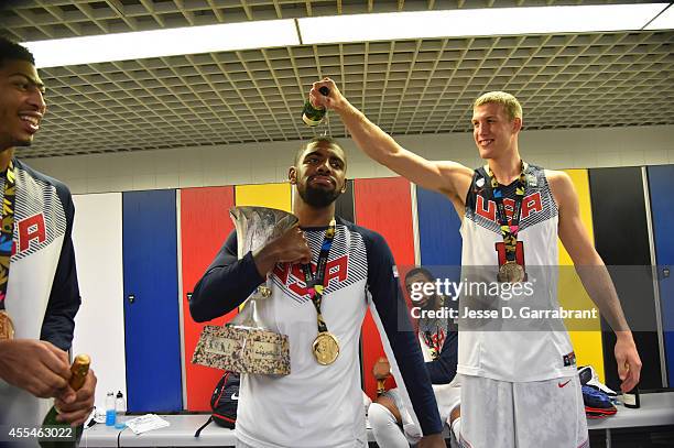 Mason Plumlee pours champagne on Kyrie Irving of the USA Men's National Team as they celebrates in the locker room after defeating the Serbia...