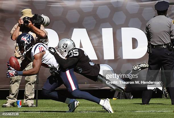 DeAndre Hopkins of the Houston Texans catches a 12-yard touchdown pass against Chimdi Chekwa of the Oakland Raiders during the third quarter at O.co...