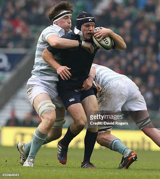 Jon Hudson of Oxford is tackled by Charlie O'Sullivan and Scott Annett during the Varisty match between Oxford University and Cambridge University at...