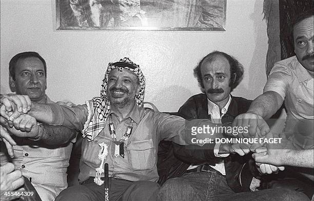 Palestine Liberation Organisation chairman Yasser Arafat shown in a picture dated 30 August 1982 in Beirut, shakes hands with his Lebanese...