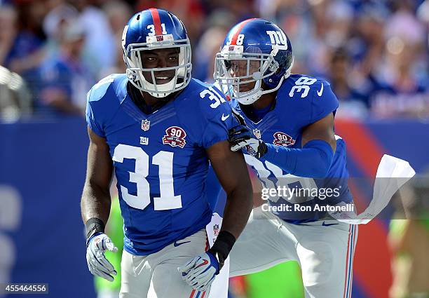 Cornerback Zack Bowman celebrates with cornerback Trumaine McBride of the New York Giants against the Arizona Cardinals during a game at MetLife...