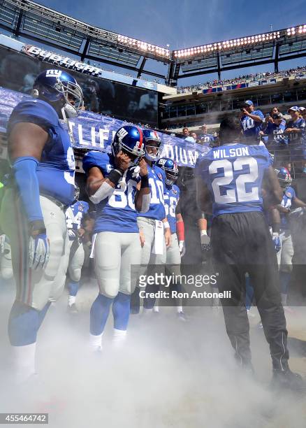 The New York Giants prepare to take the field against the Arizona Cardinals during a game at MetLife Stadium on September 14, 2014 in East...