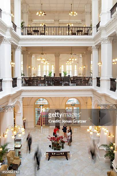 The colonial style lobby from the second floor walkway of the Raffles Hotel.