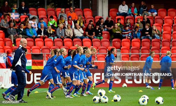 Iceland's players warm up prior to the UEFA Women's European Championship Euro 2013 group B football match Iceland vs Germany on July 14, 2013 in...