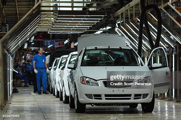 Workers at the Iranian Khodro car manufacturing plant make Iranian car models as well as vehicles under license of the French company Peugeot on...