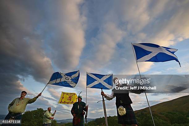 Duncan Thomson, Brian McCutcheon, John Patterson and Arthur Murdoch, from King of Scots Robert the Bruce Society, hold the Scottish flags as they...