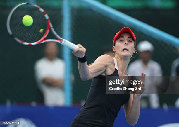 Alize Conrnet of France returns a shot during her match against Yulia Putintseva of Kazakhstan during day one of the 2014 WTA Guangzhou Open at Taint...