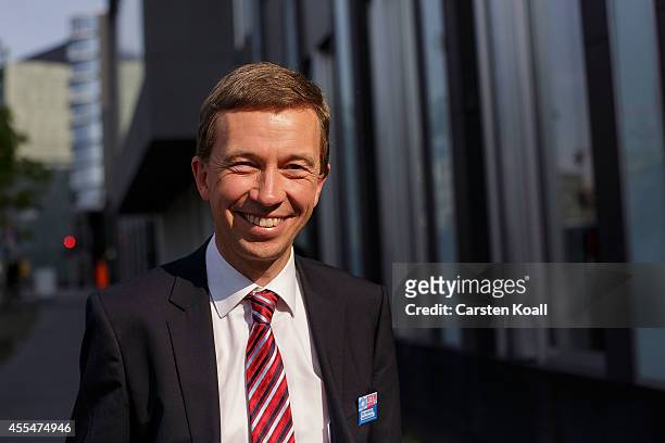 Bernd Lucke, head of the Alternative fuer Deutschland political party, smiles as he left a pressconference the day after the AfD finished with strong...
