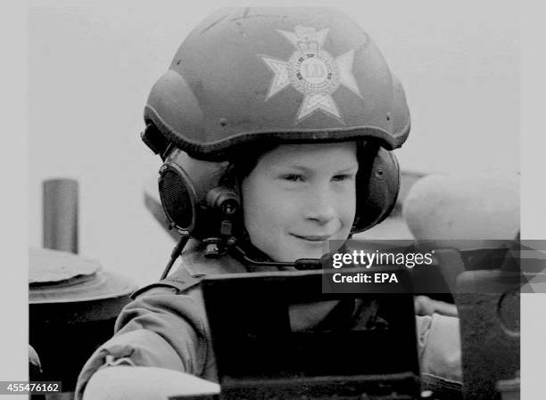 Britian's Prince Harry, youngest son of the Prince and Princess of Wales, wearing full dress uniform rides in a light tank during a visit to the...