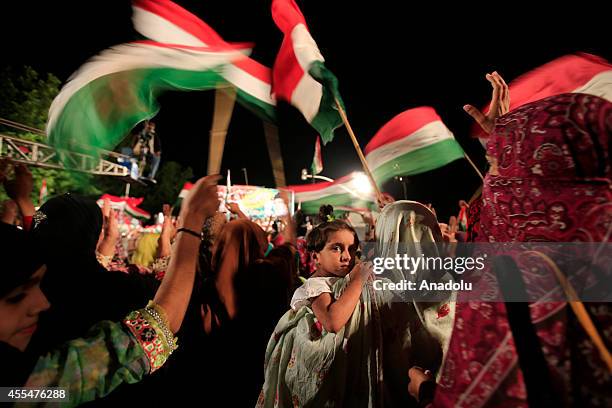 Anti-government protestors wave flags during the ongoing anti-government protest in Islamabad's Red Zone where the state buildings and parliament...